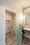 Well-lit master bath with separate toilet room 
